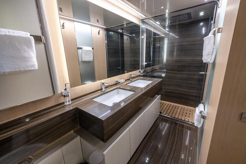 Sea Metri V Yacht Photos Pics Luxurious modern bathroom with double sinks, glass shower, and elegant wood accents on Amer 94 yacht.