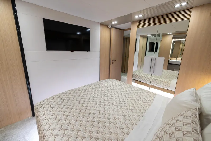 Sea Metri V Yacht Photos Pics Luxurious bedroom interior in Amer 94 yacht, featuring modern design and mirrored closet.