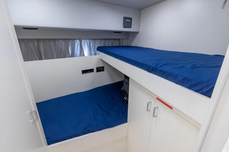 Sea Metri V Yacht Photos Pics Compact bunk beds with blue bedding in a 2017 Amer 94 model interior.