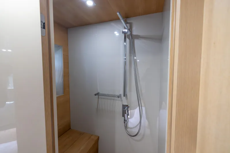 Sea Metri V Yacht Photos Pics Modern shower area in Amer 94 yacht, 2017 model, featuring sleek fixtures and wooden accents.