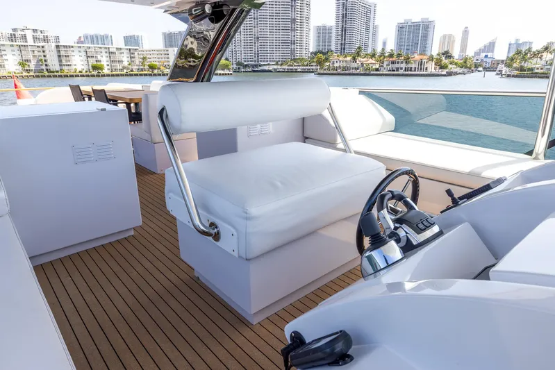 Sea Metri V Yacht Photos Pics Luxurious 2017 Amer 94 yacht interior with white seating and modern controls, overlooking city skyline.