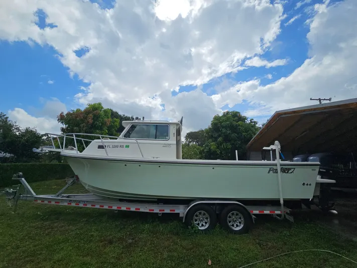  Yacht Photos Pics 2017 Parker 2820 XLD Sport Cabin boat on trailer under cloudy sky.