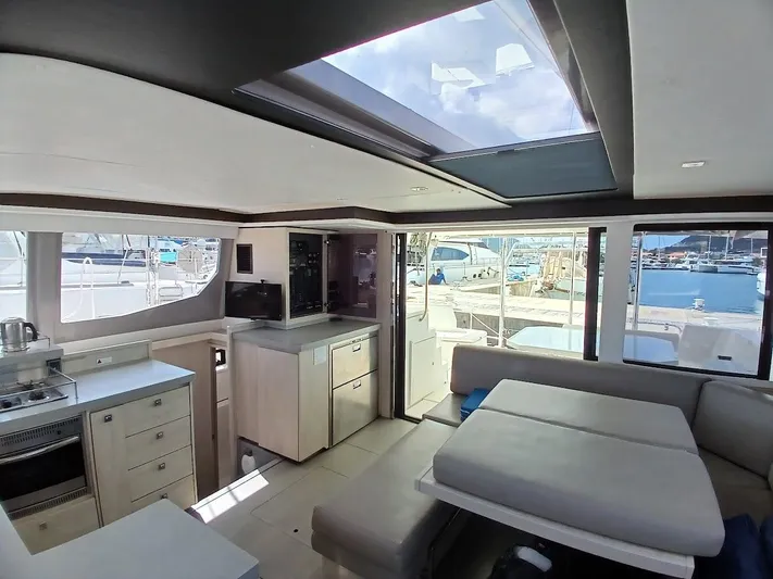 Sail La Vie Yacht Photos Pics Luxurious interior of 2019 Leopard 45 catamaran with modern kitchen and seating area.