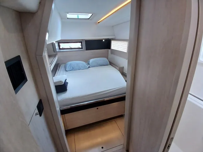 Sail La Vie Yacht Photos Pics Cozy bedroom interior of 2019 Leopard 45 yacht with skylight and modern design.