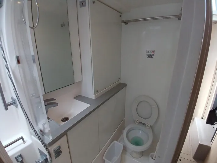 Sail La Vie Yacht Photos Pics Modern bathroom in a 2019 Leopard 45 yacht, featuring a toilet and sink.