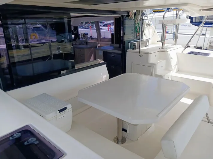Sail La Vie Yacht Photos Pics Spacious deck of 2019 Leopard 45 catamaran with seating and table.