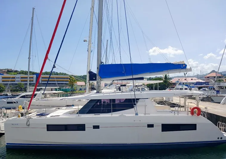Sail La Vie Yacht Photos Pics 2019 Leopard 45 catamaran docked at marina, featuring blue sail cover.