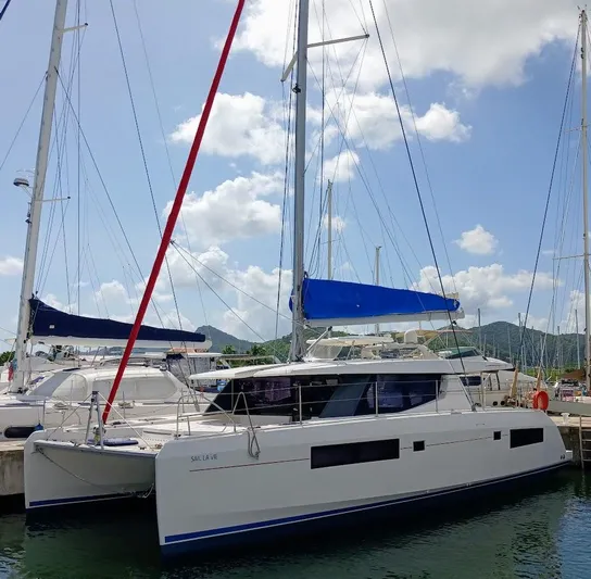 Sail La Vie Yacht Photos Pics 2019 Leopard 45 catamaran docked at marina under blue sky.