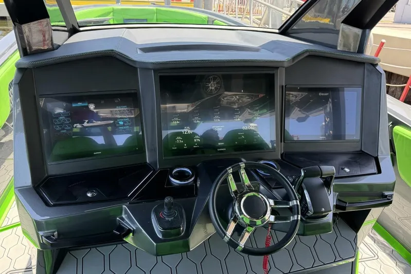  Yacht Photos Pics Cockpit of 2023 Adrenaline 47 boat with advanced digital displays and steering wheel.