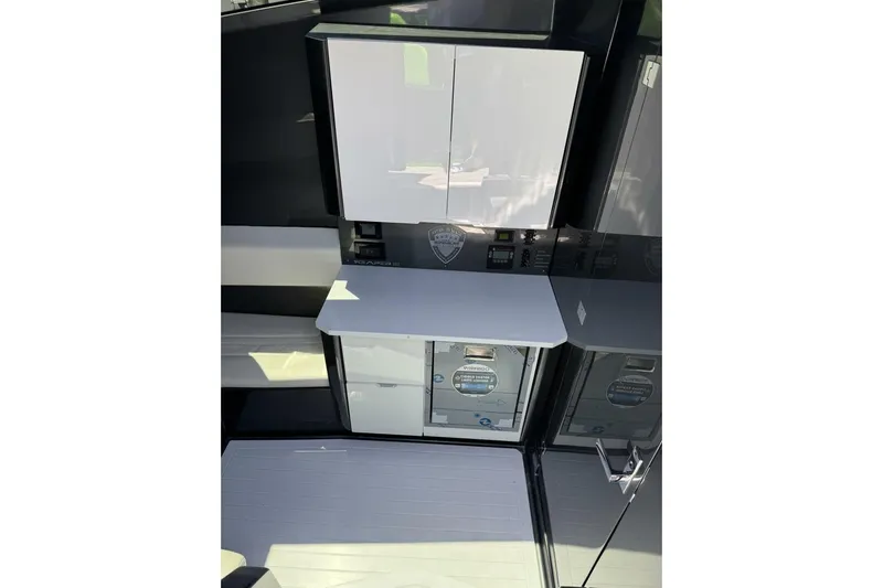  Yacht Photos Pics Modern interior of 2023 Adrenaline 47 boat with sleek cabinetry and control panel.