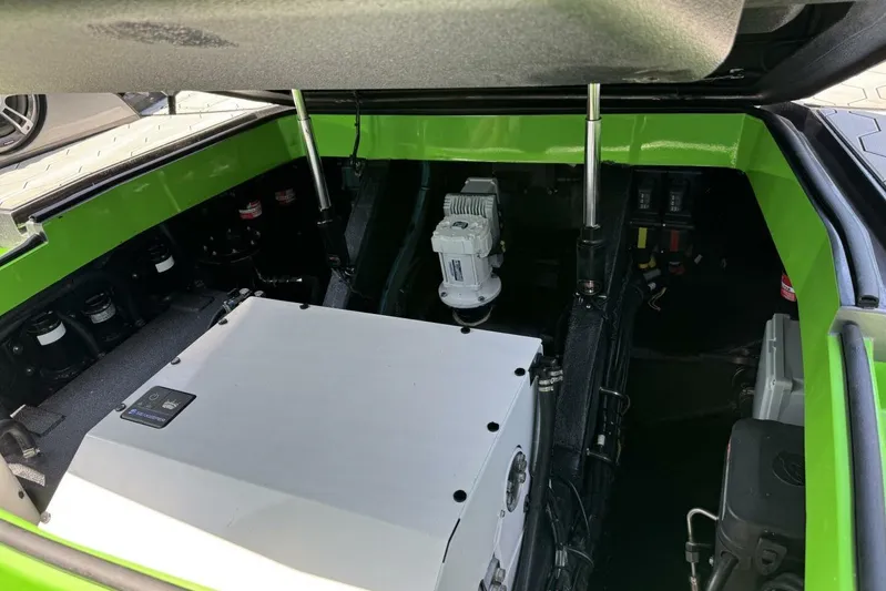  Yacht Photos Pics Open engine compartment of 2023 Adrenaline 47 boat, showcasing mechanical components.