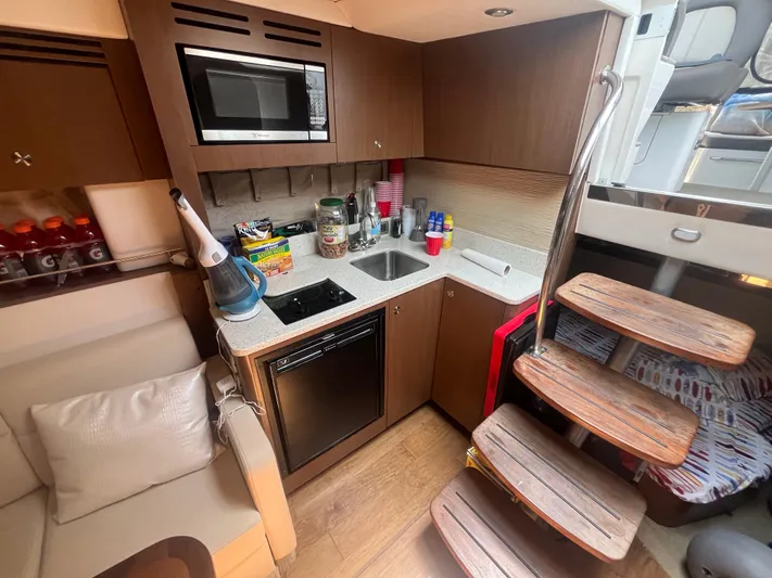 Sweet Emily II Yacht Photos Pics 2015 Sea Ray 350 Sundancer yacht interior kitchen with modern amenities and wooden stairs.