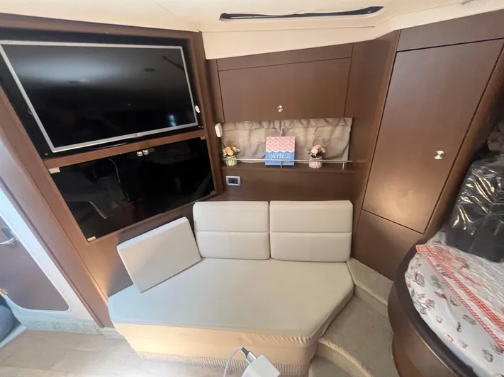 Sweet Emily II Yacht Photos Pics Interior of 2015 Sea Ray 350 Sundancer with TV, seating, and storage.