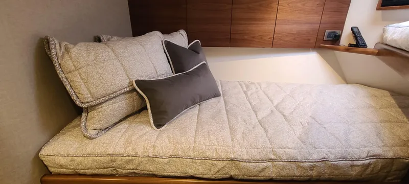 Nomad Yacht Photos Pics 2024 Viking 54 Convertible interior with cozy bed and pillows.