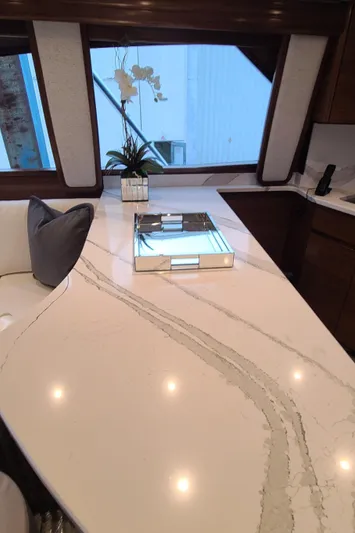 Nomad Yacht Photos Pics Luxurious interior of 2024 Viking 54 Convertible yacht with elegant countertop and decor.