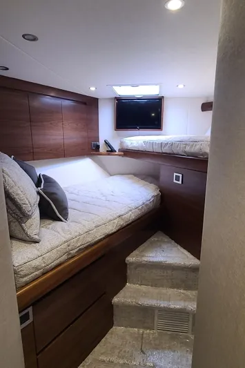 Nomad Yacht Photos Pics 2024 Viking 54 Convertible yacht cabin with cozy beds and modern design.