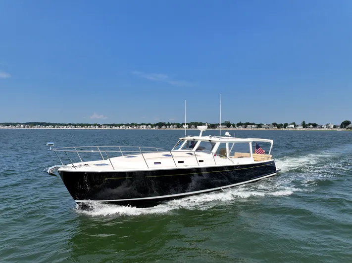 Highlander Yacht Photos Pics 2017 MJM 50z yacht cruising on open water under clear blue sky.