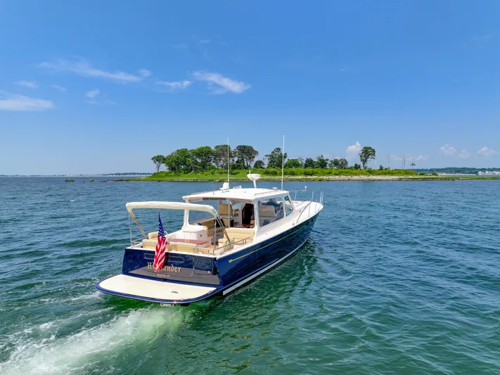 Highlander Yacht Photos Pics 2017 MJM 50z yacht cruising on a sunny day near a lush island.