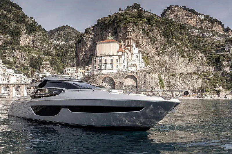  Yacht Photos Pics Luxurious 2016 Riva 76' Perseo yacht cruising near scenic coastal cliffs.