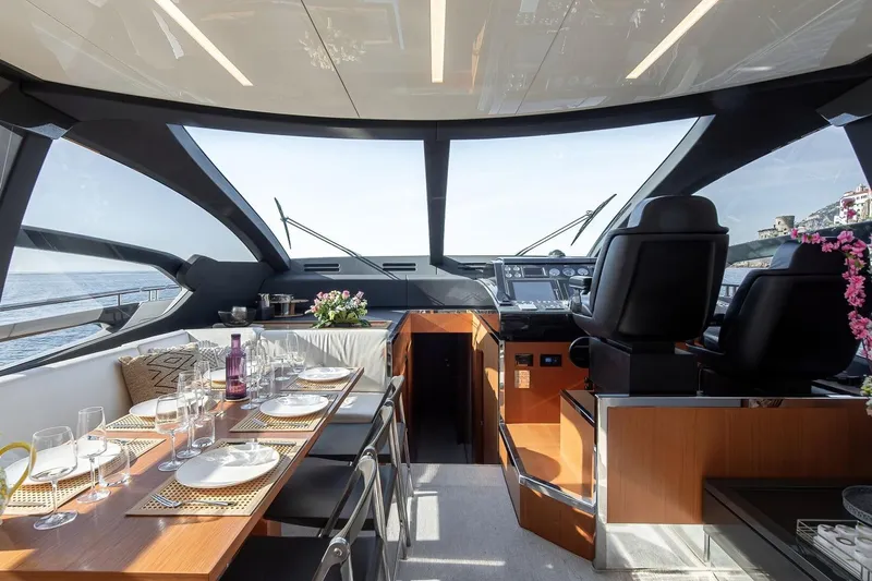  Yacht Photos Pics Luxurious interior of 2016 Riva 76' Perseo yacht with elegant dining setup and modern helm.