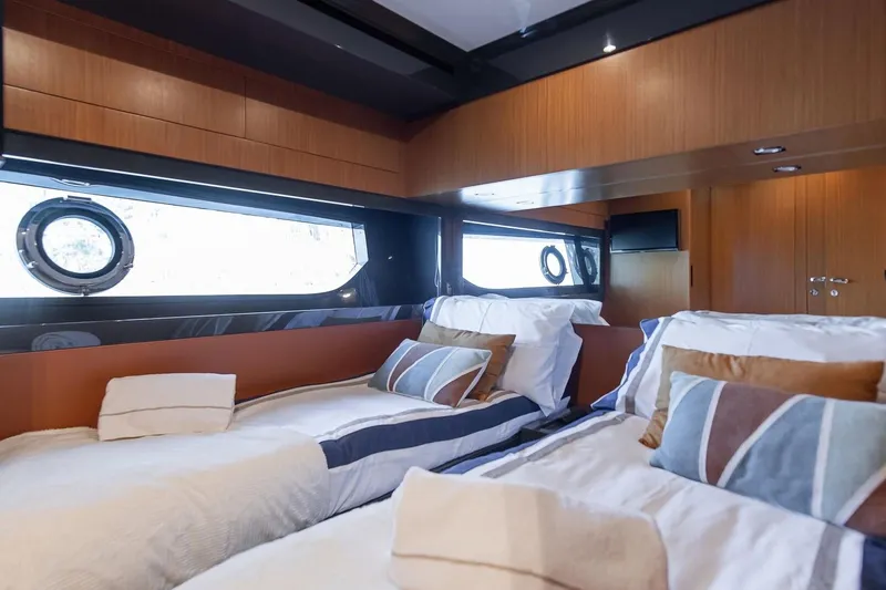  Yacht Photos Pics Luxurious cabin interior of 2016 Riva 76' Perseo yacht with twin beds and porthole windows.