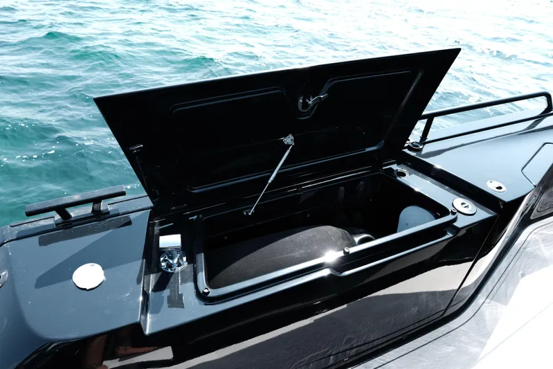 Ex Felgenhauer Yacht Photos Pics Open storage compartment on 2023 BRABUS Shadow 1200 Cross Cabin boat, with ocean backdrop.