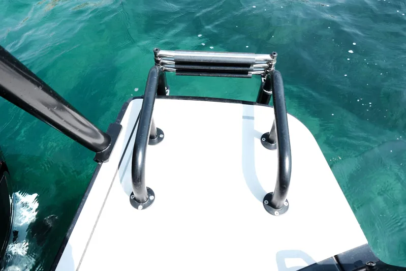 Ex Felgenhauer Yacht Photos Pics 2023 BRABUS Shadow 1200 Cross Cabin boat ladder over clear blue water.