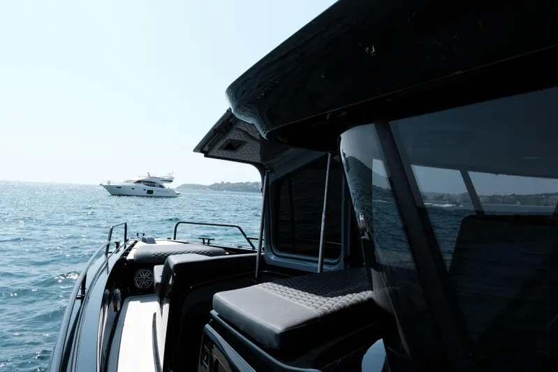 Ex Felgenhauer Yacht Photos Pics 2023 BRABUS Shadow 1200 Cross Cabin on open sea, luxury yacht in background.