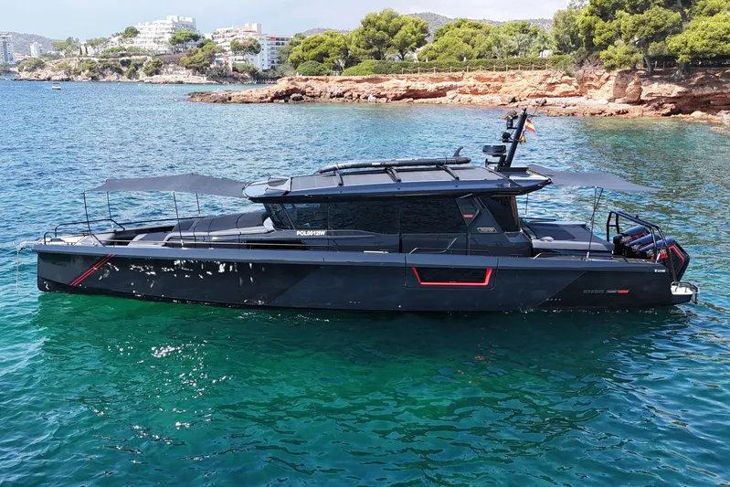 Ex Felgenhauer Yacht Photos Pics 2023 BRABUS Shadow 1200 Cross Cabin yacht on clear blue water near rocky coastline.