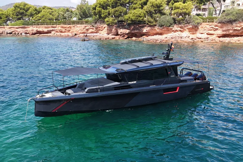 Ex Felgenhauer Yacht Photos Pics 2023 BRABUS Shadow 1200 Cross Cabin boat on clear blue water near rocky shoreline.