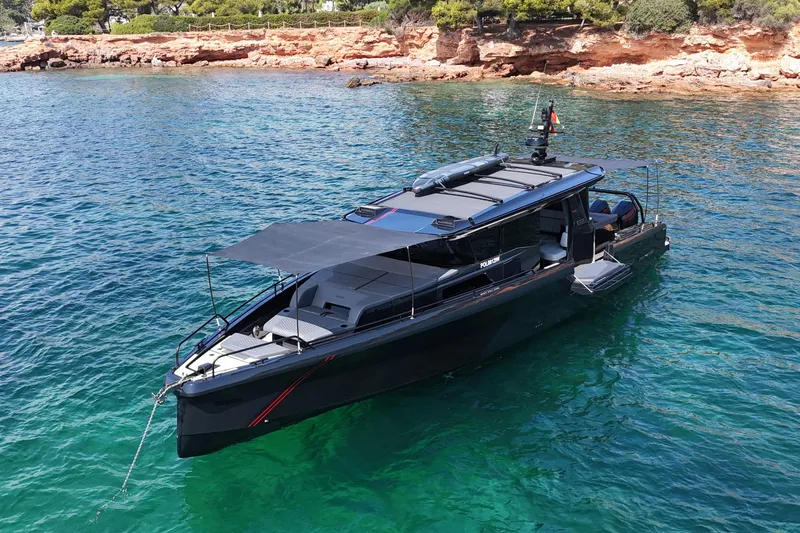 Ex Felgenhauer Yacht Photos Pics 2023 BRABUS Shadow 1200 Cross Cabin yacht anchored in clear turquoise waters.