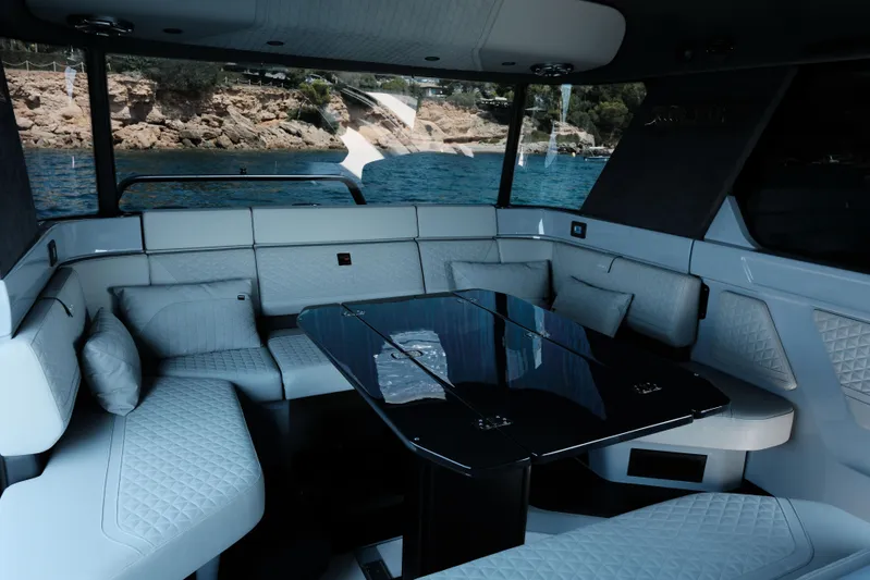 Ex Felgenhauer Yacht Photos Pics Luxurious interior of 2023 BRABUS Shadow 1200 Cross Cabin yacht with elegant seating and table.