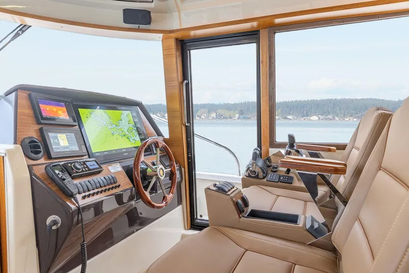  Yacht Photos Pics Interior of 2025 Ranger Tugs R-43 S boat with navigation equipment and leather seating.