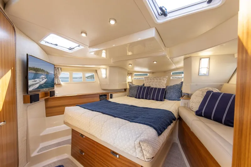 Yacht Photos Pics Luxurious interior of 2025 Ranger Tugs R-43 S yacht with cozy bedroom and modern amenities.