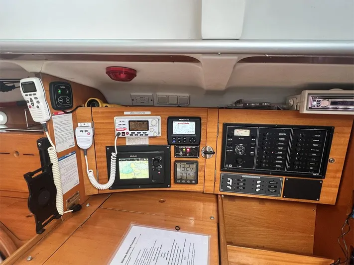 Nirvana Yacht Photos Pics Navigation and control panel of a 2001 Beneteau First 40.7 sailboat, featuring communication devices.