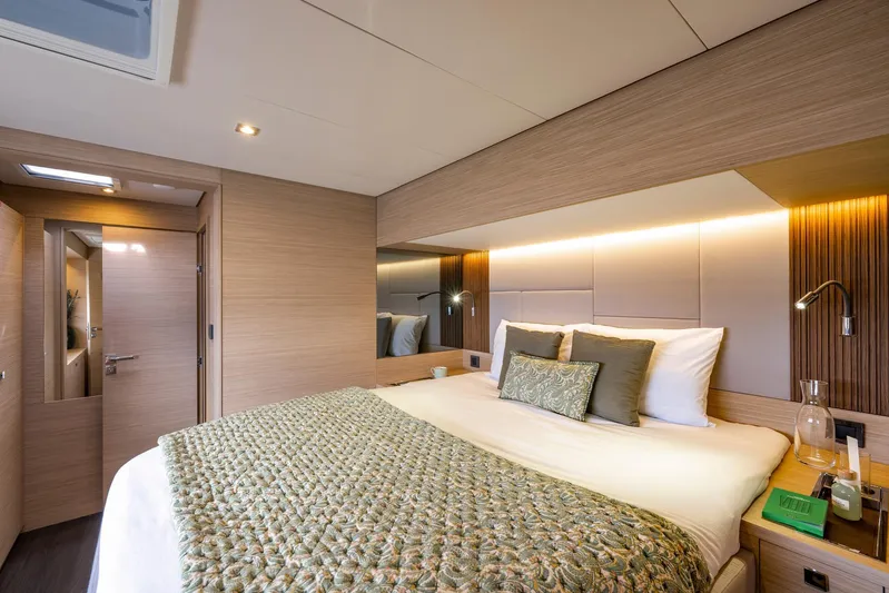  Yacht Photos Pics Luxurious bedroom interior of 2026 Lagoon 60 yacht with modern design and ambient lighting.