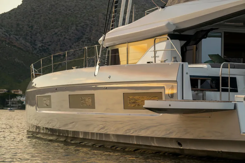  Yacht Photos Pics Luxurious 2026 Lagoon 60 yacht reflecting sunset on calm waters.