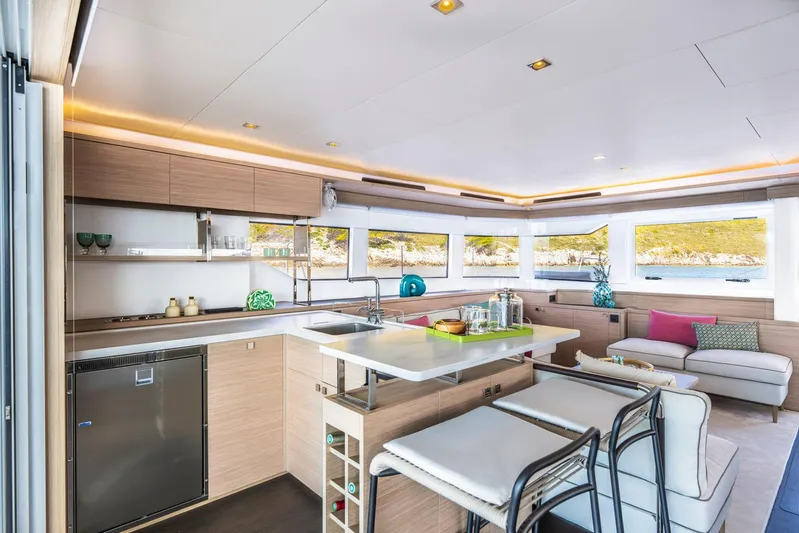  Yacht Photos Pics Luxurious interior of 2026 Lagoon 60 yacht with modern kitchen and seating area.