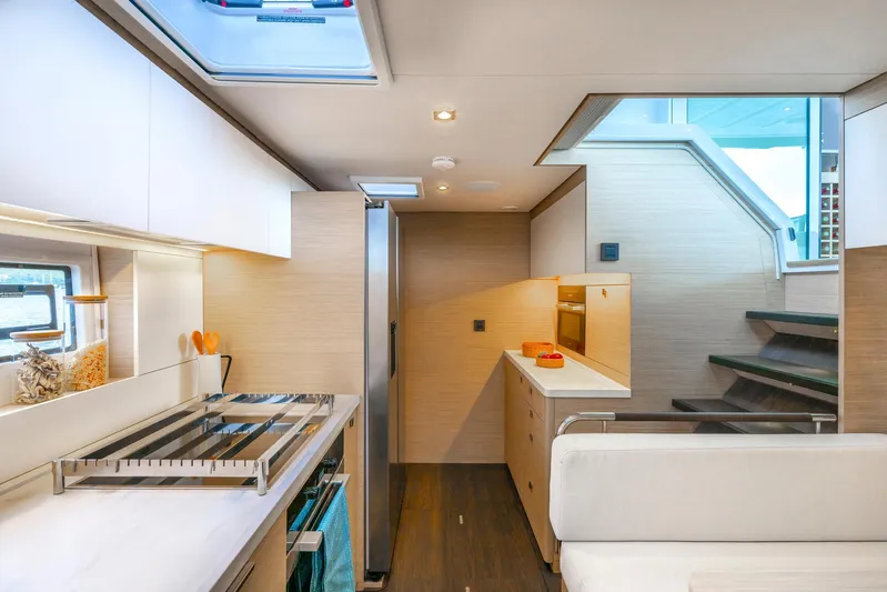  Yacht Photos Pics Modern kitchen interior of 2026 Lagoon 60 yacht with sleek design and ample natural light.