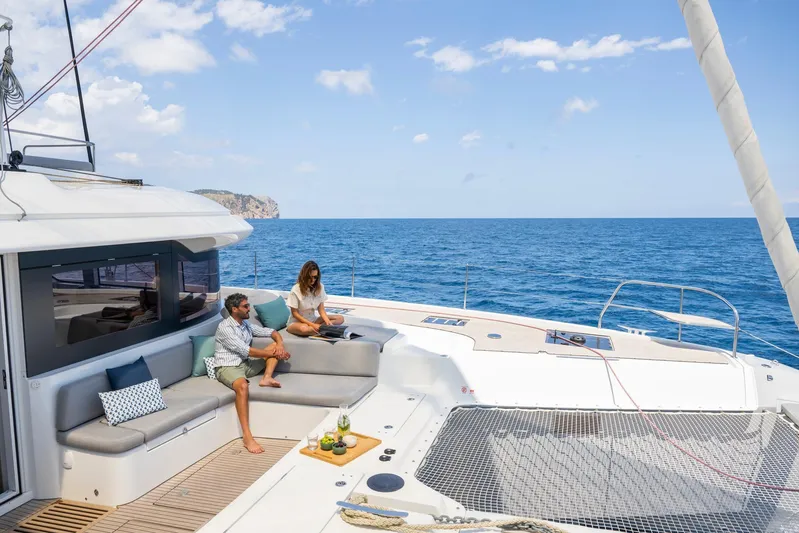  Yacht Photos Pics Couple relaxing on Lagoon 60 yacht, 2026 model, with ocean view.