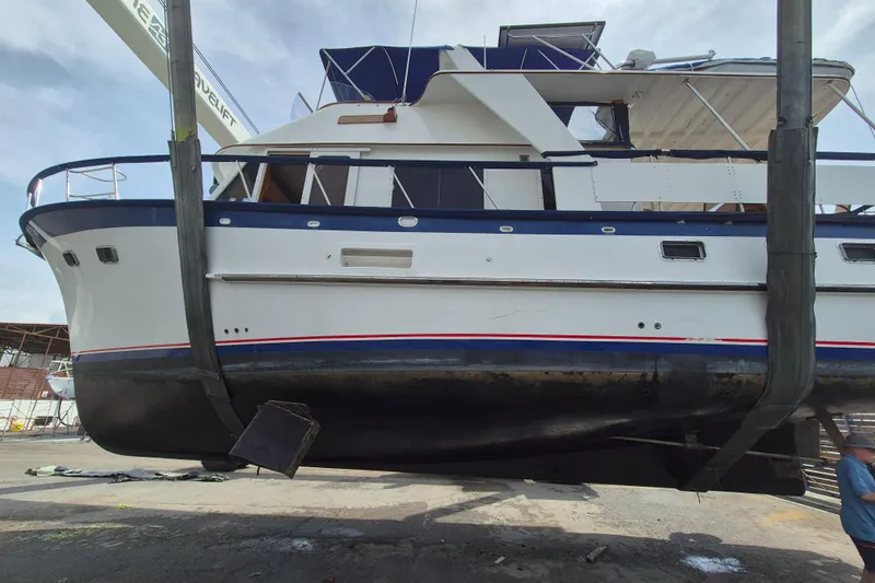 Ballena Blanca Yacht Photos Pics 1985 DeFever 44 Trawler in dry dock, side view with blue and white hull.