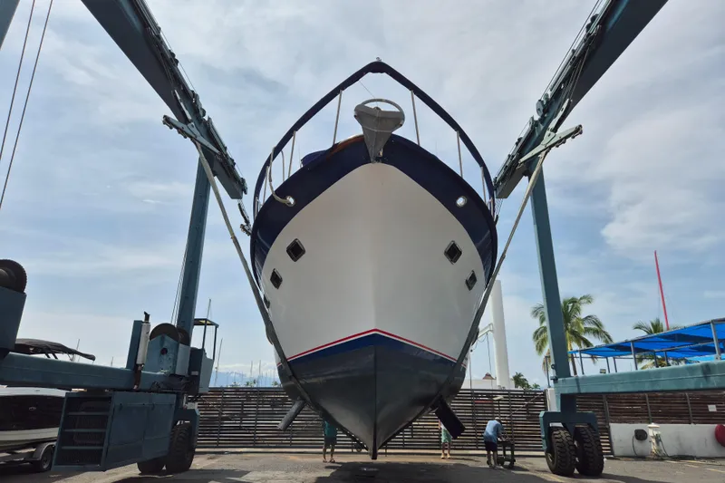 Ballena Blanca Yacht Photos Pics 1985 DeFever 44 Trawler in dry dock, viewed from below, with blue sky background.