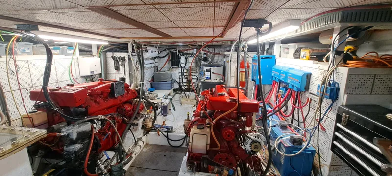Ballena Blanca Yacht Photos Pics Engine room of 1985 DeFever 44 Trawler with red engines and organized wiring.