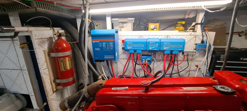 Ballena Blanca Yacht Photos Pics Engine room of 1985 DeFever 44 Trawler with red engine and electrical systems.