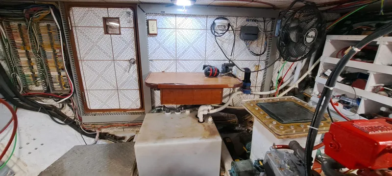 Ballena Blanca Yacht Photos Pics Engine room of a 1985 DeFever 44 Trawler with various equipment and wiring.