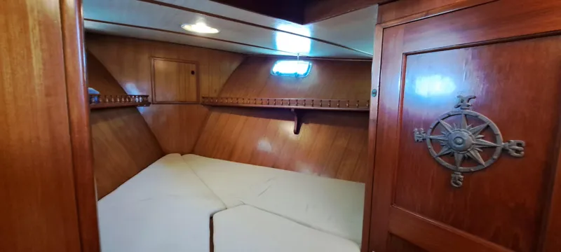 Ballena Blanca Yacht Photos Pics 1985 DeFever 44 Trawler cabin with wooden interior and nautical decor.