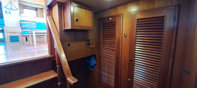 Ballena Blanca Yacht Photos Pics 1985 DeFever 44 Trawler interior with wooden cabinetry and stairs.