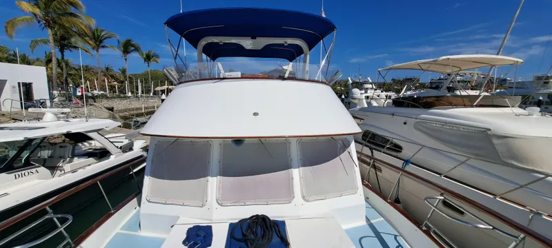 Ballena Blanca Yacht Photos Pics 1985 DeFever 44 Trawler docked at marina under clear blue sky.