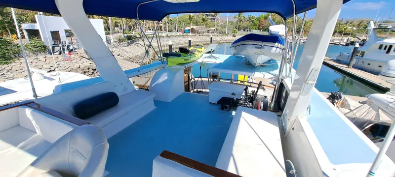 Ballena Blanca Yacht Photos Pics 1985 DeFever 44 Trawler deck with seating, canopy, and marina view.