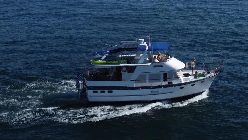 Ballena Blanca Yacht Photos Pics 1985 DeFever 44 Trawler cruising on open water, side view.